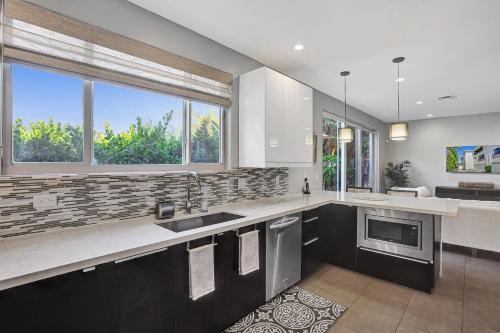 a large kitchen with a sink and a window at Victoria Park Overlook in Fort Lauderdale