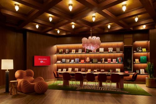a dining room with a table and chairs at Virgin Hotels Dallas in Dallas