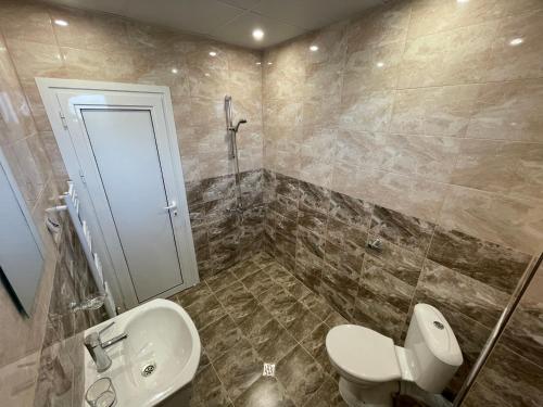 a bathroom with a toilet and a sink at Villa Stoyanovata Kashta in Samokov