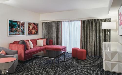 a living room with a red couch and a table at Flamingo Las Vegas Hotel & Casino in Las Vegas
