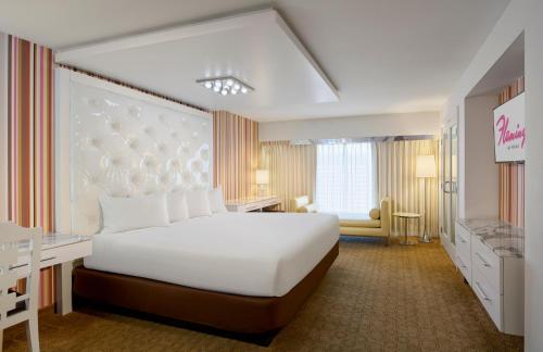 a bedroom with a large white bed in a room at Flamingo Las Vegas Hotel & Casino in Las Vegas