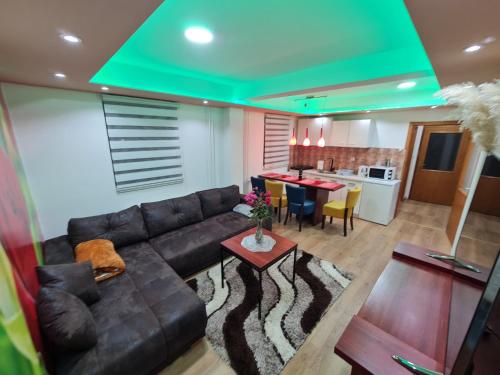 a living room with a couch and a table and a kitchen at Apartman's Ana Pale-OC Jahorina No.2 in Pale