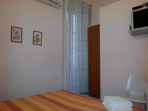 a bedroom with a bed and a tv and a window at Amarfia Bed & Breakfast - Your Home In Salerno in Salerno