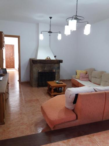 a living room with a couch and a fireplace at LA CALDERETA CASA RURAL in La Oliva