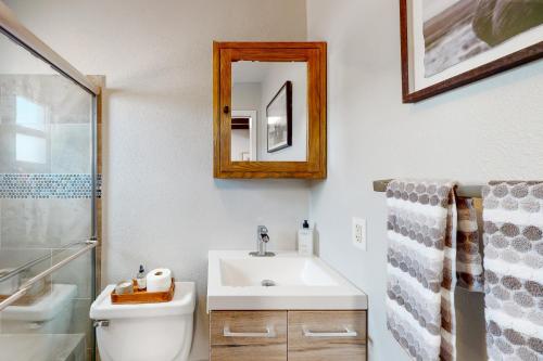 a bathroom with a sink and a toilet and a mirror at A Place on Palm - Unit 5 in Phoenix
