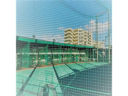 a view of a tennis court through a fence at Sunset Hills Inn Naha - Vacation STAY 77434v in Naha