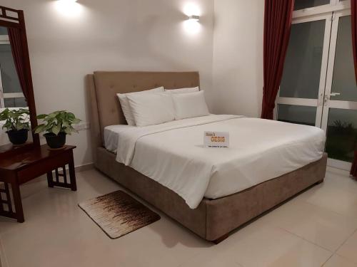 a bedroom with a bed with a sign on it at OESIS - Stylish Holiday Home in the heart of Galle in Galle