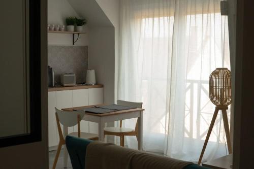 a living room with a table and a window at Studio Ouistreham entre centre-ville et plages in Ouistreham