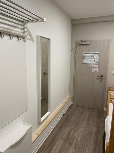 a hallway with a door and a mirror in a room at Hostel-Centrum in Hamburg