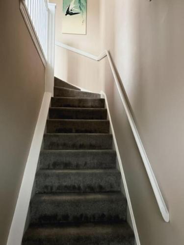 a flight of stairs in a building with a painting at Mews house 5 minutes walk from the sea in Cleethorpes