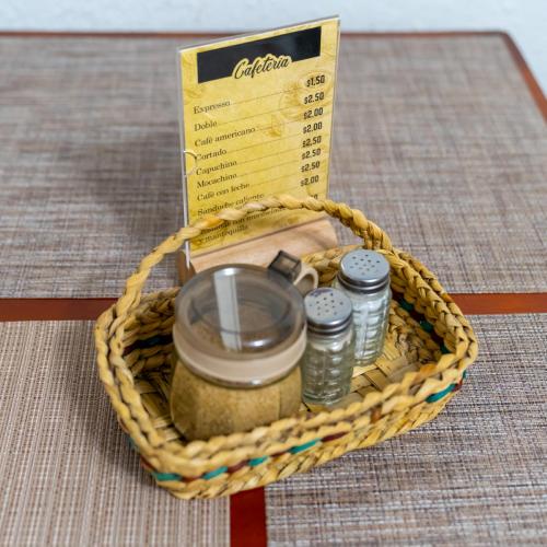 a wicker basket with a jar of food and a box at Mashy´s Hostal in Otavalo