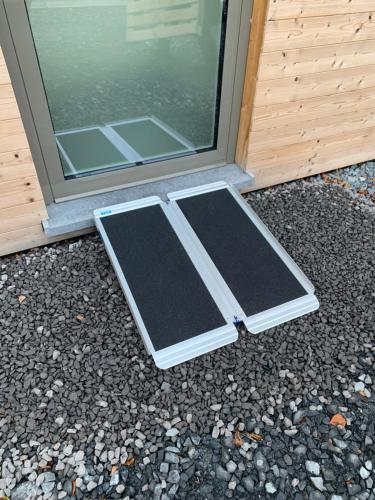 a door with two mats on the ground in front of it at L’annexe in Bastogne
