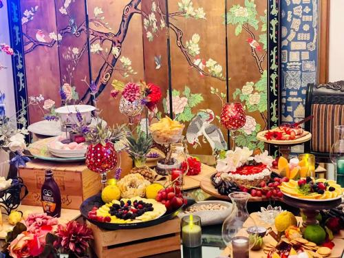 a table topped with plates of food and fruit at La Casita Inn Bustamante in Bustamante