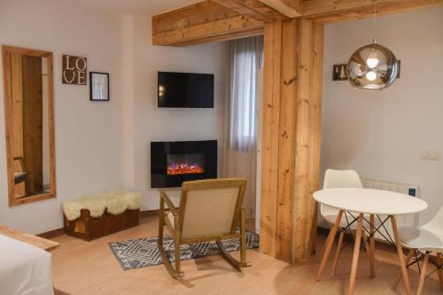 a living room with a table and a fireplace at Envalira Vacances - Woody in Pas de la Casa