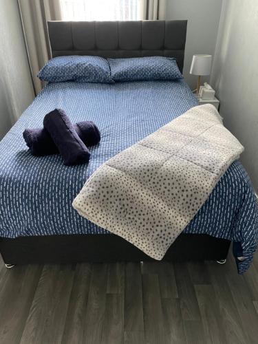 a bedroom with a bed with two pillows on it at Helens Lybster cosy cottage on NC500 in Lybster