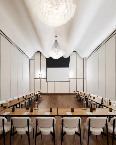 an empty conference room with tables and chairs at Virgin Hotels Dallas in Dallas