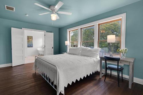 a bedroom with a bed and a ceiling fan at Milk Bath Springs House in Dripping Springs
