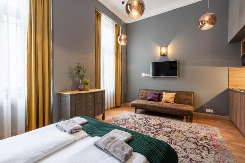 a hotel room with a bed and a couch at The Pearl of the Heart of Budapest in Budapest