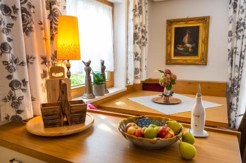 a bowl of fruit on a table in a room with a window at Villa Daringer in Mayrhofen