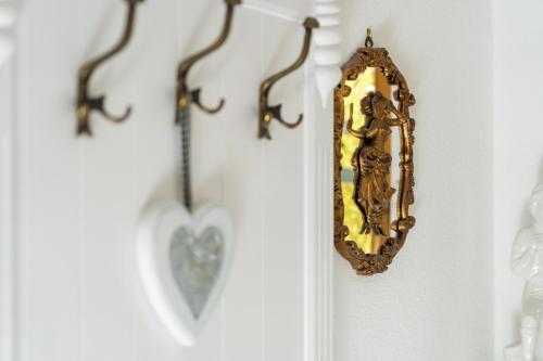 a mirror on a wall with a heart on it at Villa Daringer in Mayrhofen
