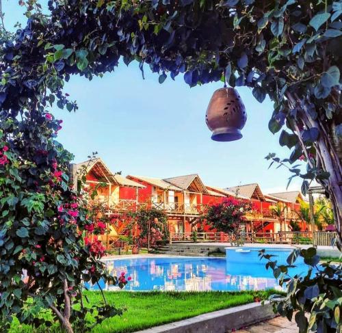 a view of a resort with a swimming pool at Casa de Praia Chalé Luís Correia Piauí in Luis Correia