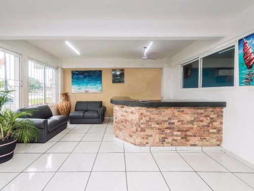 a lobby with a brick bar in a building at Hotel Puerto Inn in Veracruz