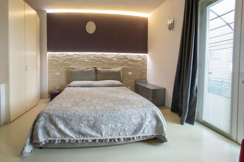 a bedroom with a bed and a large window at Minimal Chic in Verona