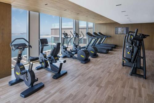 a gym with a row of treadms and cardio machines at Radisson Beach Resort Palm Jumeirah in Dubai