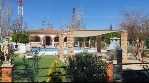 a house with a swimming pool in a yard at VILLA CUQUI in Antequera