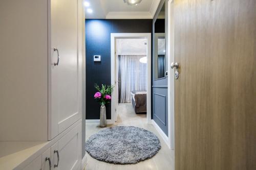 a hallway with a door to a room with a rug at DiVine Luxury Apartment Purple in Zadar