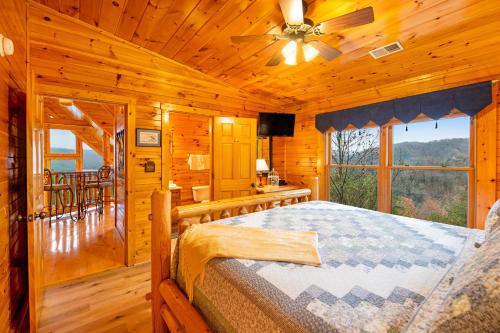 a bedroom with a bed in a log cabin at Grizzly Manor in Pigeon Forge