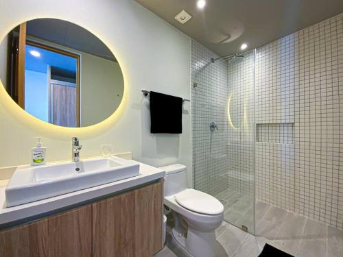 a bathroom with a sink and a toilet and a mirror at Beautiful + Luxury + Ocean View + Pool in Playa del Carmen