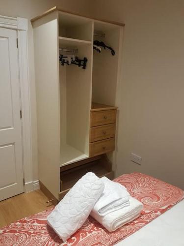a bedroom with a bed with two white towels on it at Sunnyside Lodge - Beautiful Fermanagh Holiday Home in Tamlaght