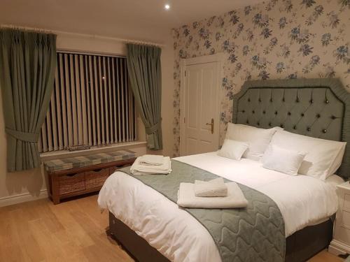 a bedroom with a large bed and a window at Sunnyside Lodge - Beautiful Fermanagh Holiday Home 