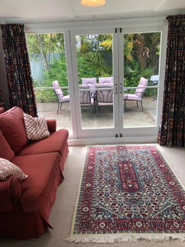 un soggiorno con divano e tappeto di Ferntree Cottage a Mapua