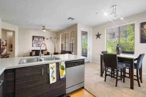 a kitchen with a sink and a table with chairs at COZY 2BR/2BA ! 5MINtoDisney ! AngelStadium!HondaCenter in Anaheim