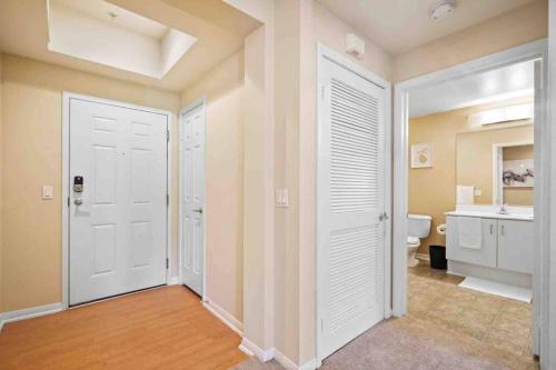 a bathroom with two white doors and a sink at COZY 2BR/2BA ! 5MINtoDisney ! AngelStadium!HondaCenter in Anaheim