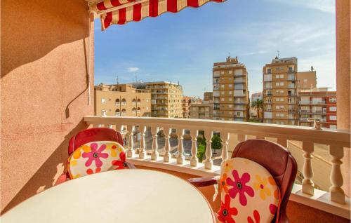 a table and chairs on a balcony with a view of the city at Amazing Apartment In Santa Pola in Santa Pola