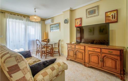 a living room with a flat screen tv and a couch at Amazing Apartment In Santa Pola in Santa Pola