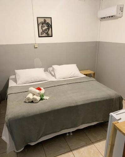 a bedroom with a bed with a stuffed animal on it at CASA MAR DE FORA in Fernando de Noronha
