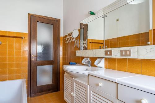 a bathroom with a sink and a mirror at Attico Montiglio - by Host4U in Brescia