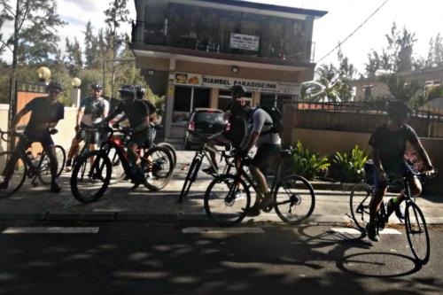 a group of people riding bikes down a street at Riambel Paradise Inn Private Apartment in Riambel