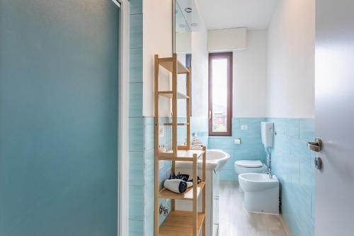 a bathroom with blue walls and a ladder to a toilet at House MaGa - by Host4U in Brescia