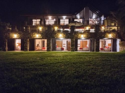 a large house at night with lights at CARDON Posada Boutique in Punta del Este