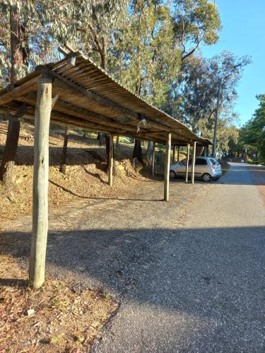 a wooden pavilion on the side of a road at CARDON Posada Boutique in Punta del Este