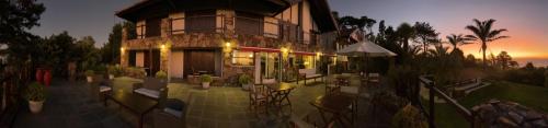 a building with tables and chairs in front of it at CARDON Posada Boutique in Punta del Este