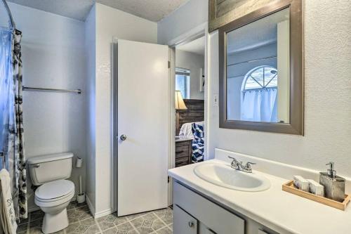 a bathroom with a toilet and a sink and a mirror at NEW! ATX Home with 3 Patios, 3 TVs, & Fire Pit in Austin