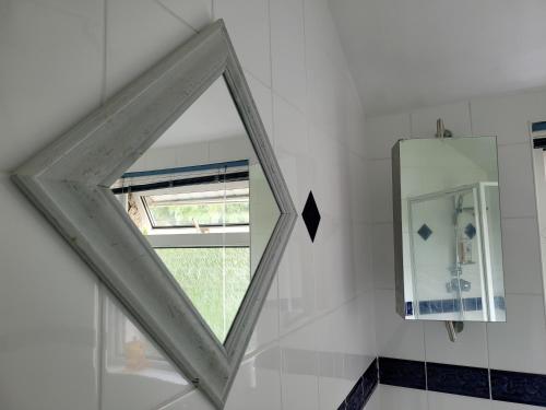 a window in a bathroom with a mirror at Shergold Rooms in Swindon