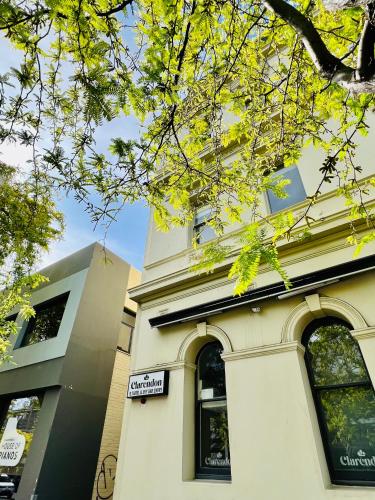 a building with a sign on the side of it at Clarendon Hotel in Melbourne
