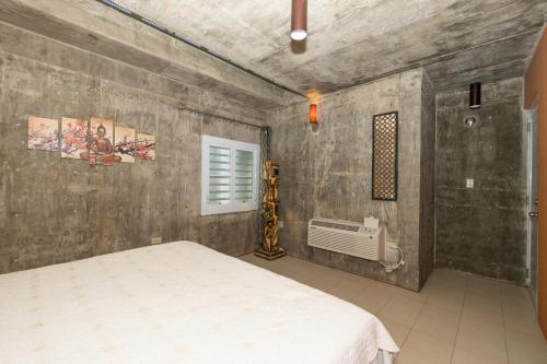 a bedroom with a white bed in a room at La Esmeralda PR in San Juan